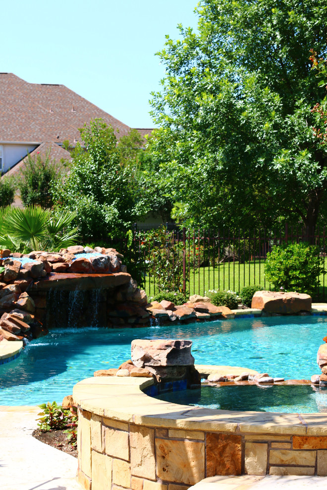 Inspiration for a large traditional backyard custom-shaped natural pool in Dallas.