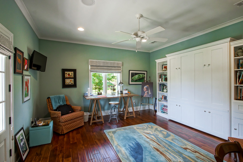 Photo of a mid-sized traditional home studio in New Orleans with green walls, medium hardwood floors, no fireplace and a freestanding desk.