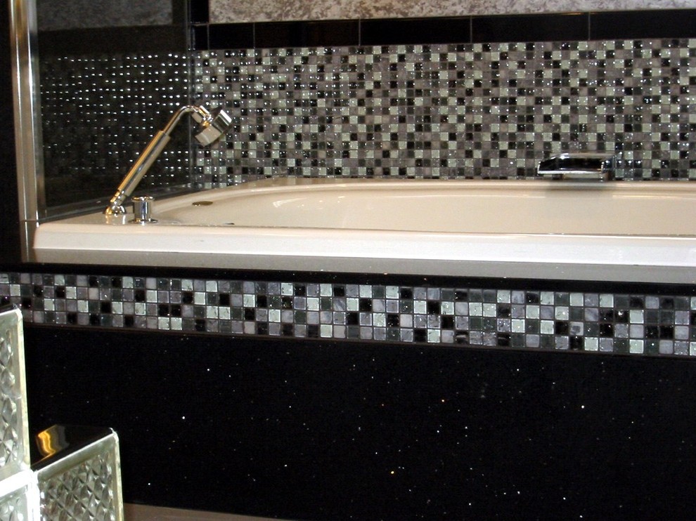 Photo of a mid-sized contemporary master bathroom in Chicago with a hot tub, black tile, black and white tile, gray tile, multi-coloured tile, white tile, mosaic tile, grey walls, porcelain floors and quartzite benchtops.