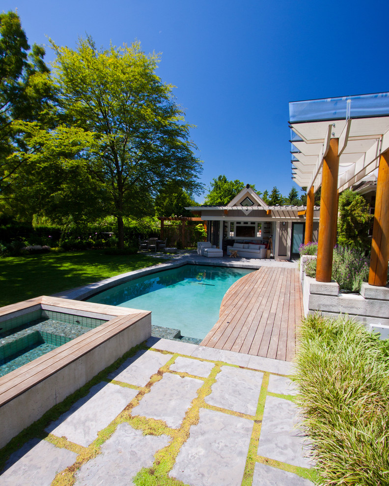 Example of a transitional backyard custom-shaped hot tub design in Vancouver