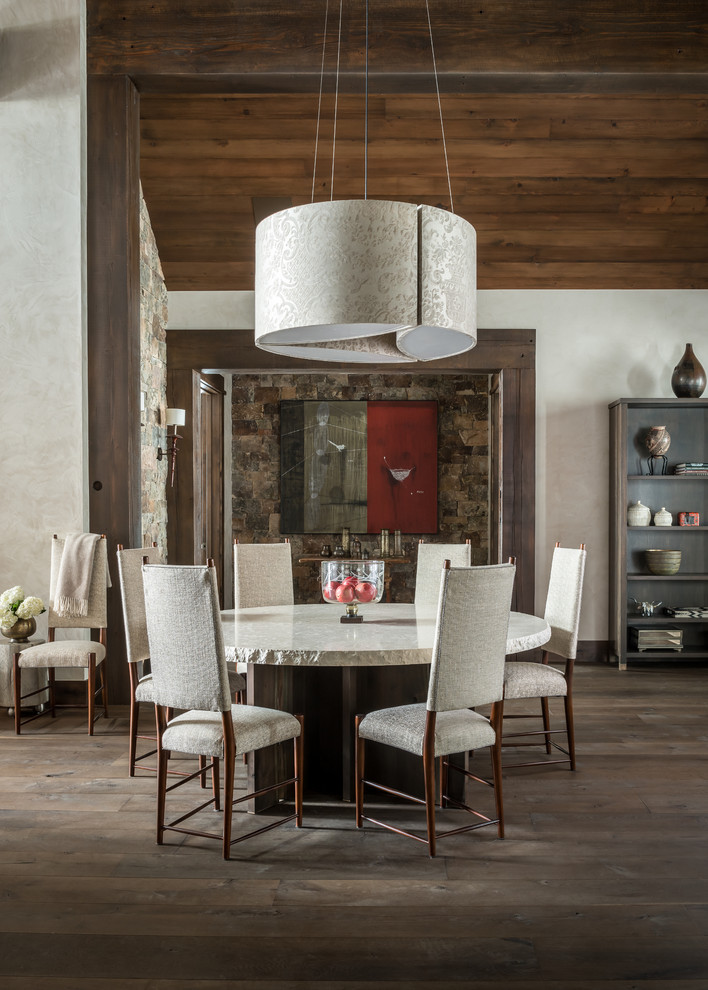 This is an example of a mediterranean open plan dining in Other with beige walls and dark hardwood floors.