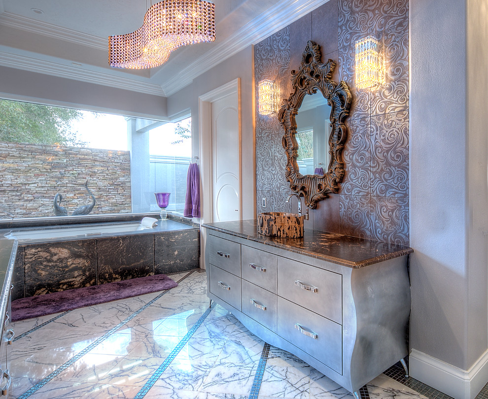 This is an example of a mid-sized eclectic master bathroom in Orlando with flat-panel cabinets, beige cabinets, beige walls, marble floors, a vessel sink and granite benchtops.