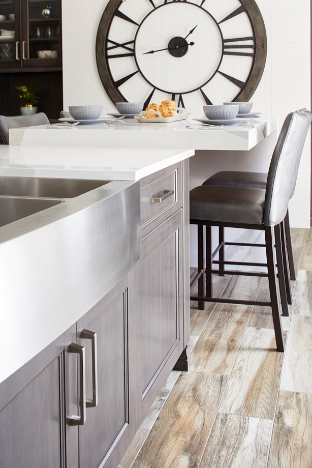 Inspiration for a mid-sized transitional l-shaped light wood floor and multicolored floor eat-in kitchen remodel in Toronto with a farmhouse sink, shaker cabinets, dark wood cabinets, granite countertops, gray backsplash, stainless steel appliances, an island and white countertops