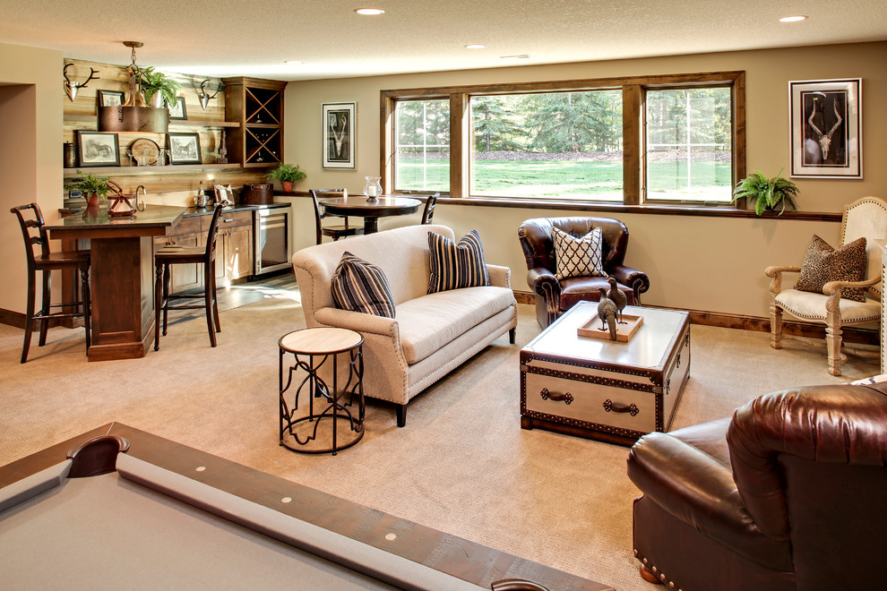 This is an example of a mid-sized country open concept family room in Minneapolis with a home bar, beige walls, carpet, no fireplace and a wall-mounted tv.