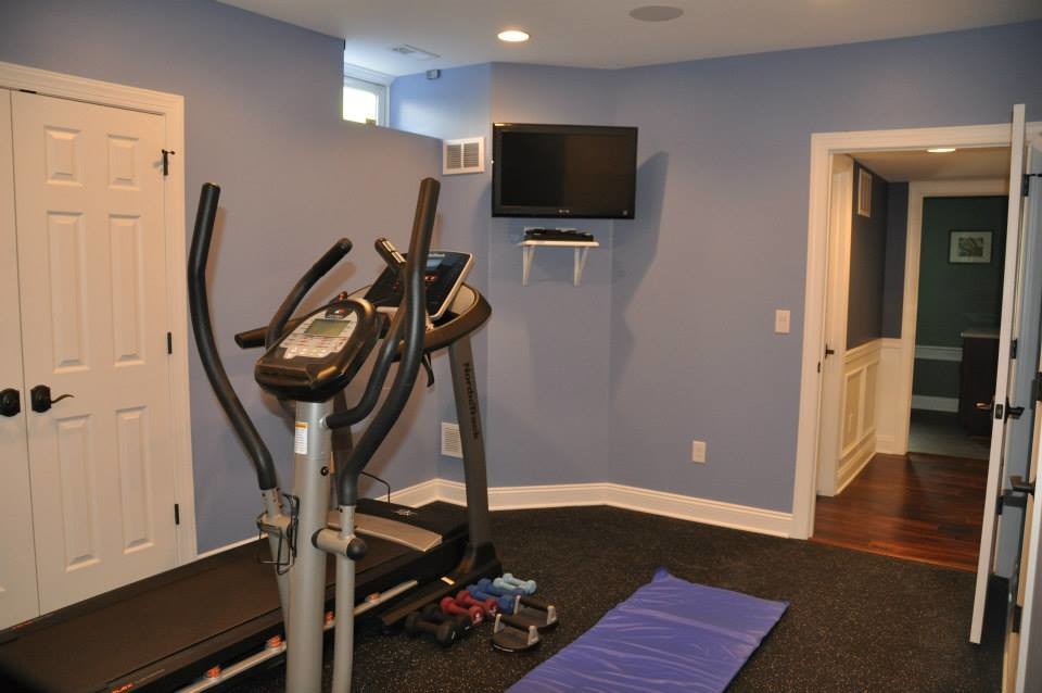 Photo of a small traditional multipurpose gym in Philadelphia with blue walls, vinyl floors and black floor.