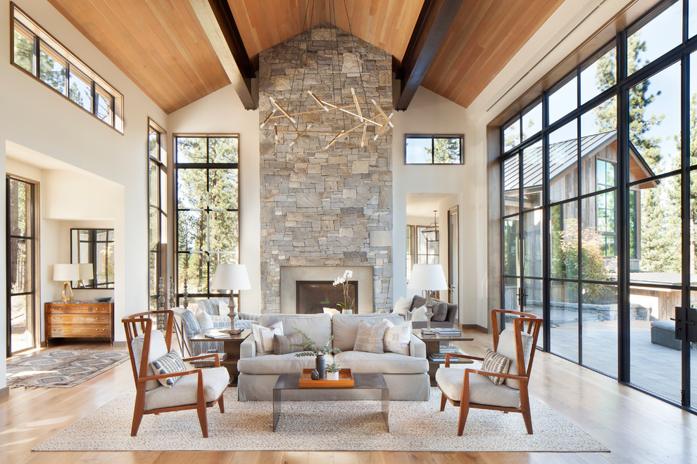 Inspiration for a large country formal open concept living room in Sacramento with white walls, light hardwood floors, a standard fireplace and a stone fireplace surround.
