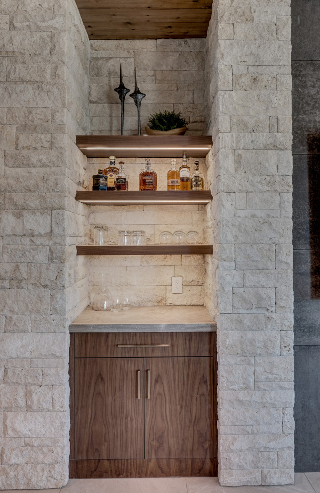 Inspiration for a small contemporary home bar in Other with floating shelves.