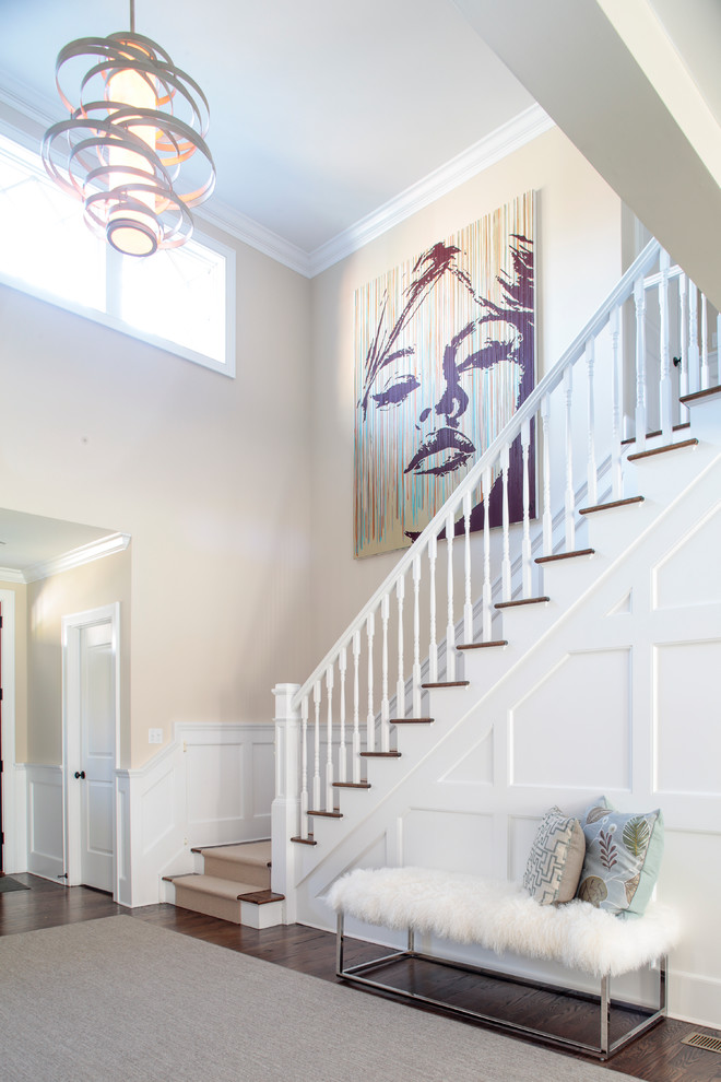 Expansive transitional foyer in New York with beige walls and dark hardwood floors.