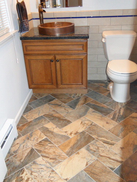 This is an example of a mid-sized traditional 3/4 bathroom in New York with raised-panel cabinets, dark wood cabinets, a two-piece toilet, beige tile, porcelain tile, white walls, plywood floors, a vessel sink, granite benchtops and multi-coloured floor.