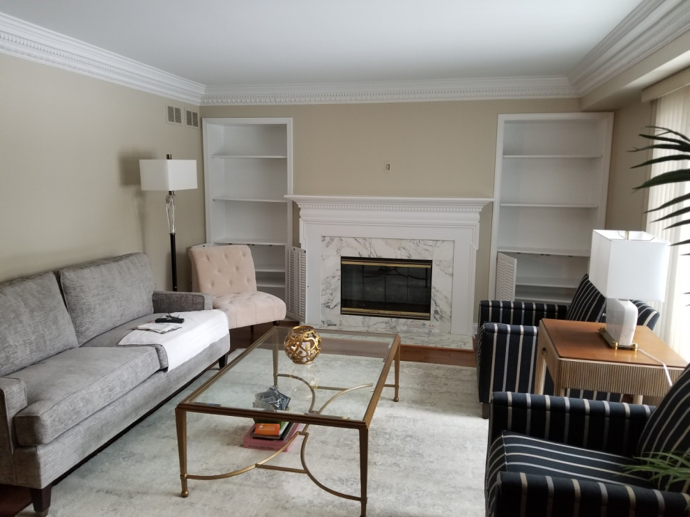 This is an example of a mid-sized modern open concept family room in Chicago with a library, beige walls, dark hardwood floors, a standard fireplace, a stone fireplace surround, no tv and white floor.