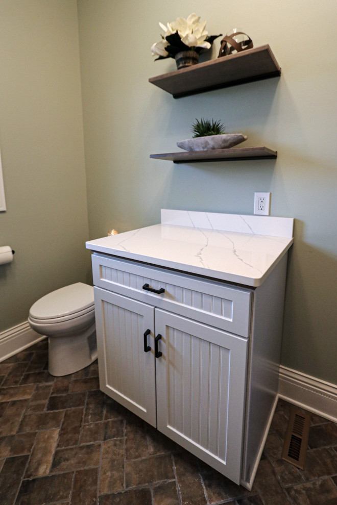 Cette photo montre un petit WC et toilettes chic en bois brun avec un placard à porte plane, WC séparés, un mur vert, un sol en carrelage de porcelaine, un lavabo encastré, un plan de toilette en quartz modifié, un sol marron, un plan de toilette blanc et meuble-lavabo sur pied.