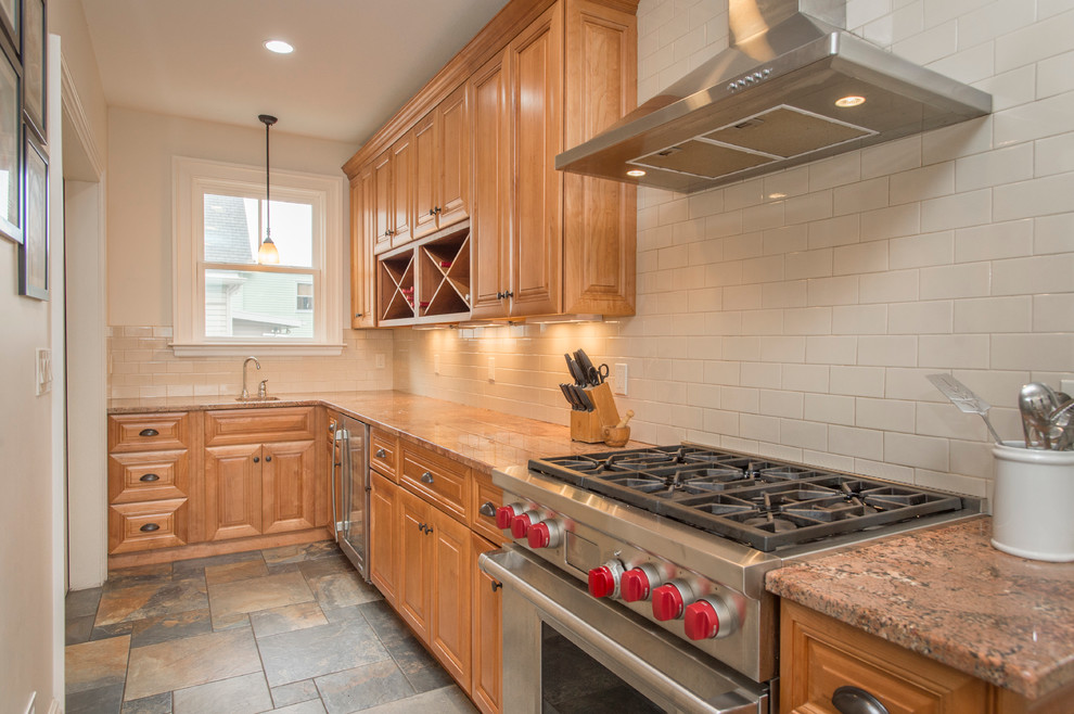 Example of a mid-sized transitional ceramic tile enclosed kitchen design in Boston with a farmhouse sink, medium tone wood cabinets, granite countertops, beige backsplash, ceramic backsplash, stainless steel appliances and no island