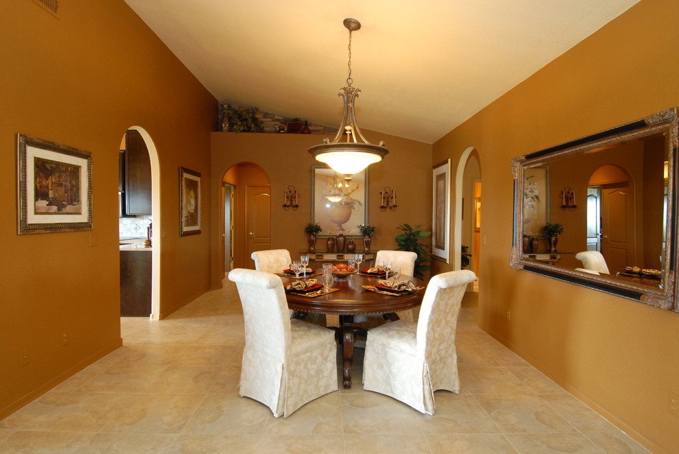 Large mediterranean separate dining room in Phoenix with brown walls and ceramic floors.