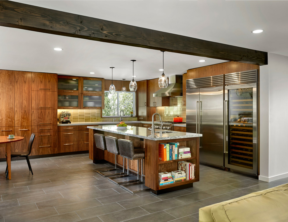 Modern l-shaped eat-in kitchen in San Francisco with flat-panel cabinets, medium wood cabinets, subway tile splashback, stainless steel appliances, ceramic floors, with island, concrete benchtops, green splashback and an undermount sink.