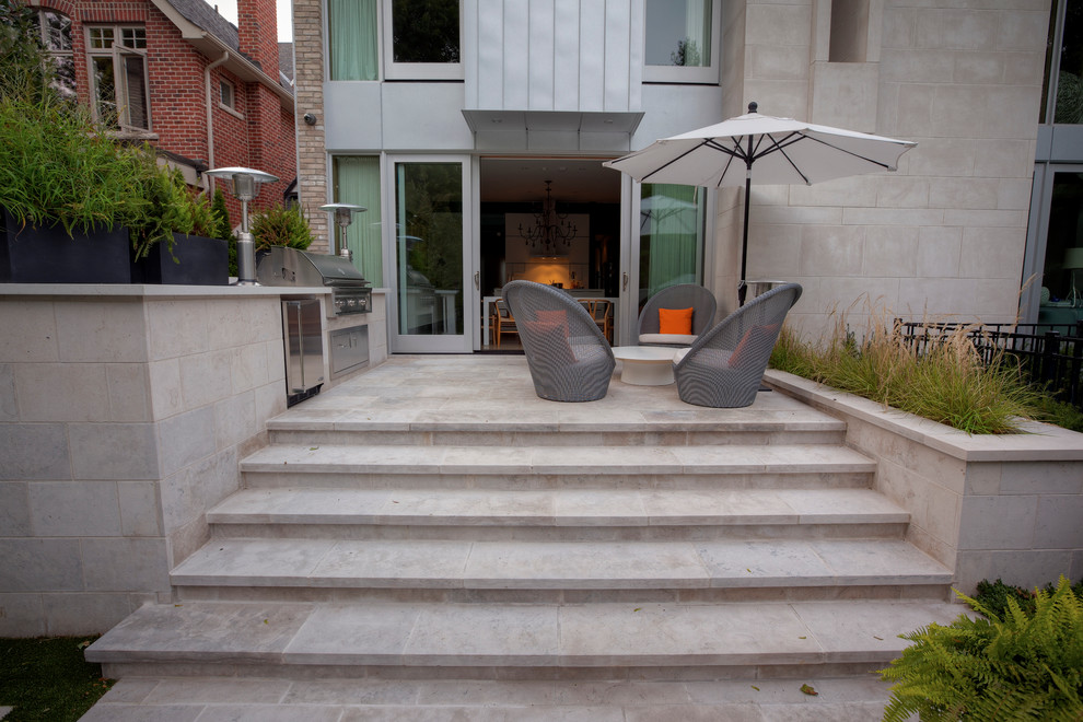 Inspiration for a small contemporary backyard patio in Toronto with an outdoor kitchen and no cover.