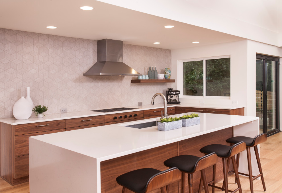 Inspiration for a large midcentury u-shaped open plan kitchen in Seattle with an integrated sink, flat-panel cabinets, dark wood cabinets, quartzite benchtops, grey splashback, porcelain splashback, stainless steel appliances, medium hardwood floors, with island, brown floor and white benchtop.