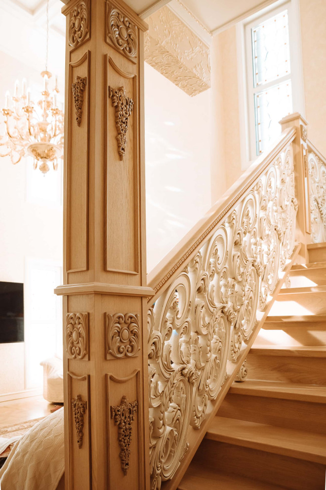 Design ideas for a large traditional wood u-shaped wood railing staircase in Moscow with wood risers, wallpapered walls and under stair storage.