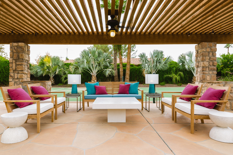 This is an example of a contemporary backyard patio in Phoenix with a pergola.