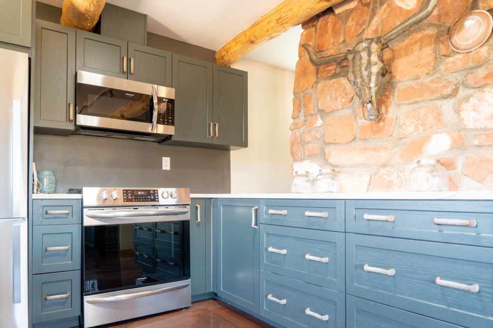 Inspiration for a transitional concrete floor kitchen remodel with shaker cabinets, blue cabinets and stainless steel appliances