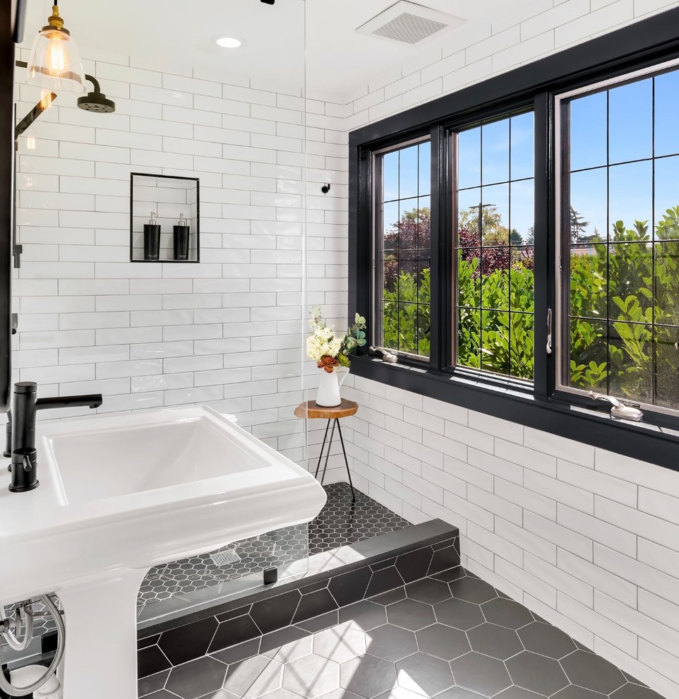 This is an example of a small transitional 3/4 bathroom in Seattle with an open shower, white tile, ceramic tile, ceramic floors, a pedestal sink, black floor and an open shower.