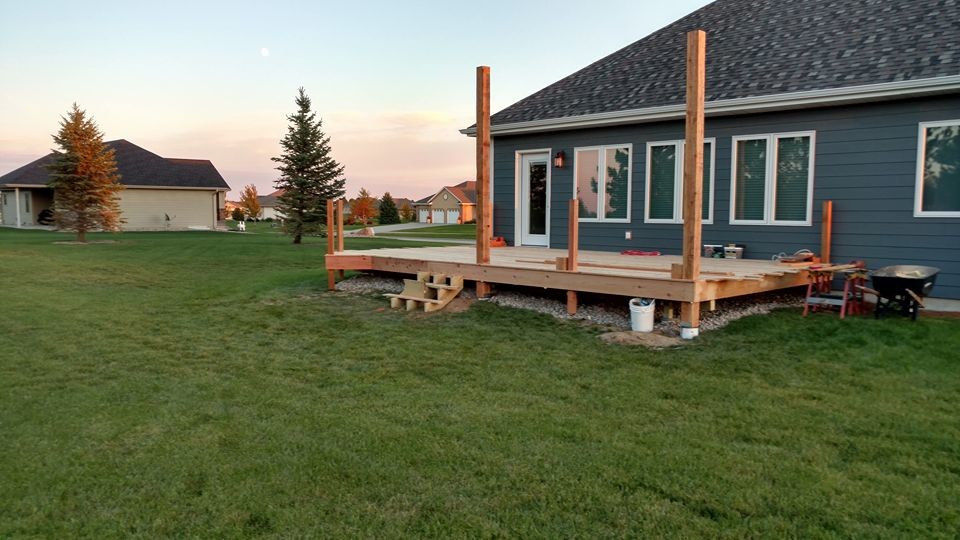 Example of a large mountain style deck design with a pergola