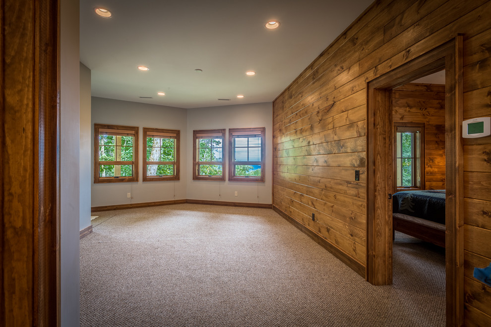 Mid-sized mountain style walk-out carpeted and beige floor basement photo in Charlotte with gray walls and no fireplace