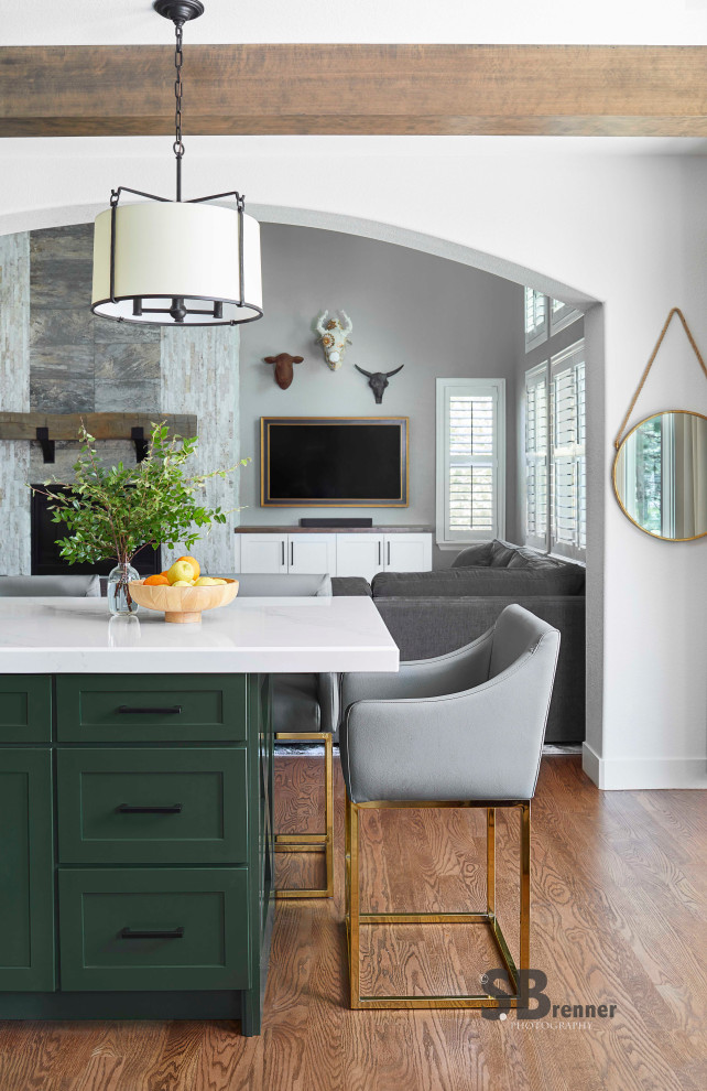 Example of a transitional galley light wood floor kitchen design in Denver with green cabinets, an island and white countertops