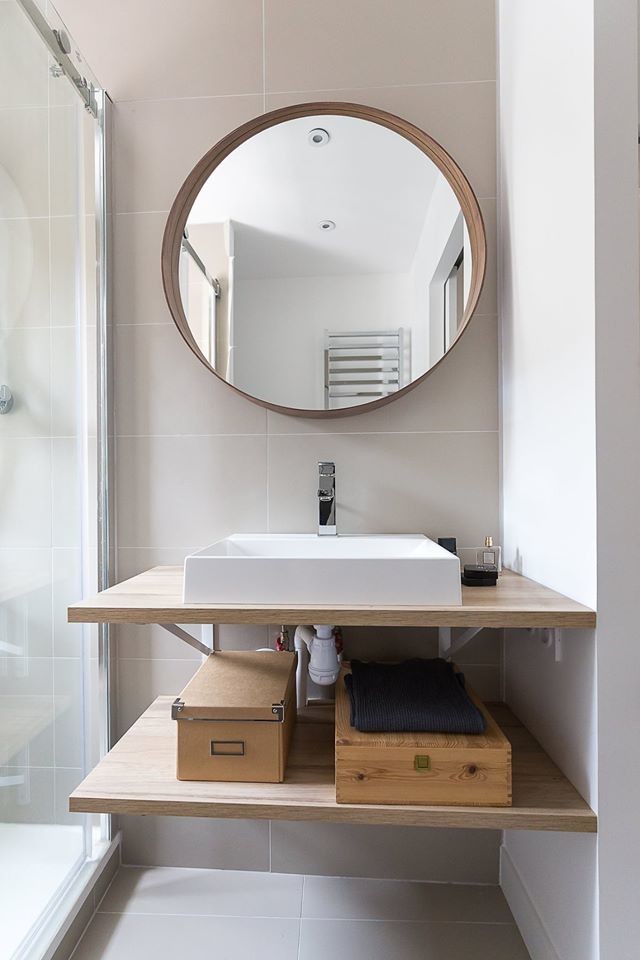 Small contemporary 3/4 bathroom in Paris with open cabinets, beige cabinets, a curbless shower, a two-piece toilet, gray tile, stone tile, grey walls, ceramic floors, a console sink, wood benchtops, grey floor, a sliding shower screen and beige benchtops.