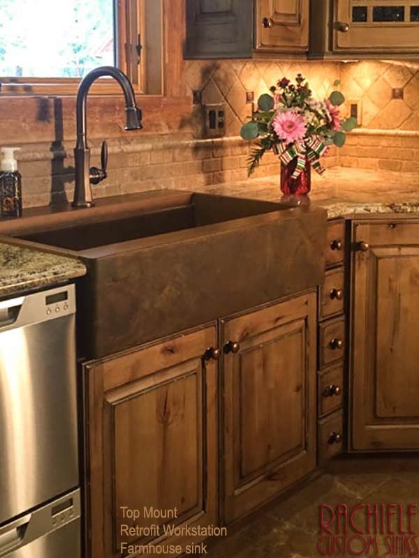 Large mountain style l-shaped ceramic tile and brown floor enclosed kitchen photo in Orlando with a farmhouse sink, raised-panel cabinets, granite countertops, beige backsplash, marble backsplash, stainless steel appliances and no island