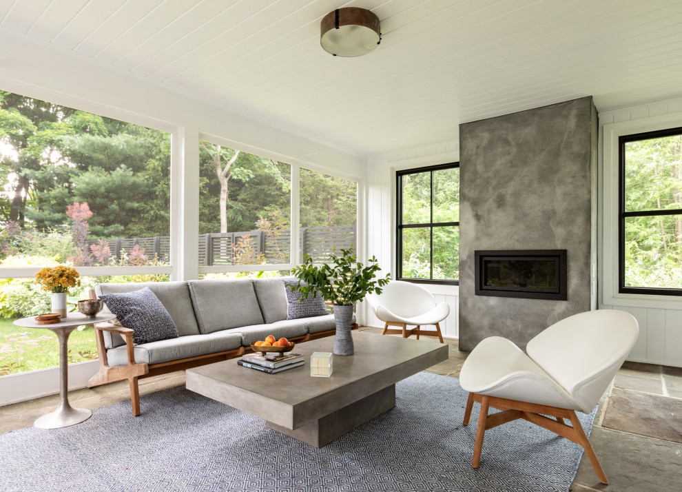 Inspiration for a mid-sized contemporary sunroom in New York with slate floors, a standard fireplace, a concrete fireplace surround, a standard ceiling and grey floor.