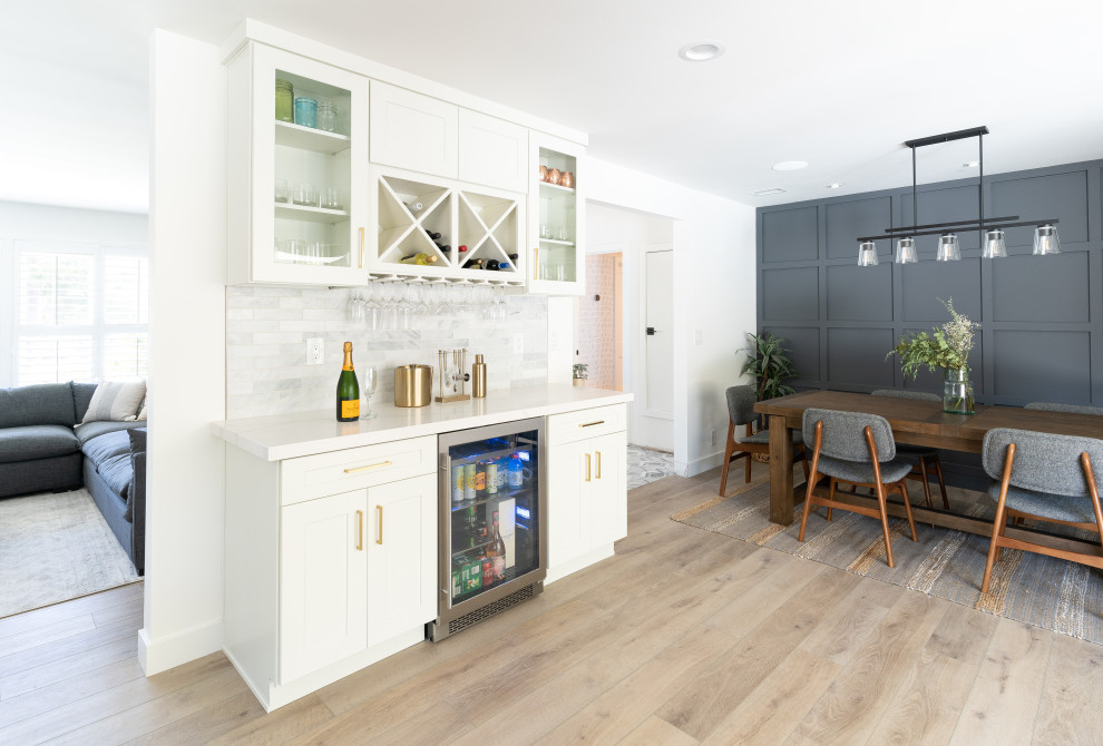 Design ideas for a large transitional kitchen/dining combo in Orange County with grey walls, vinyl floors, brown floor and decorative wall panelling.