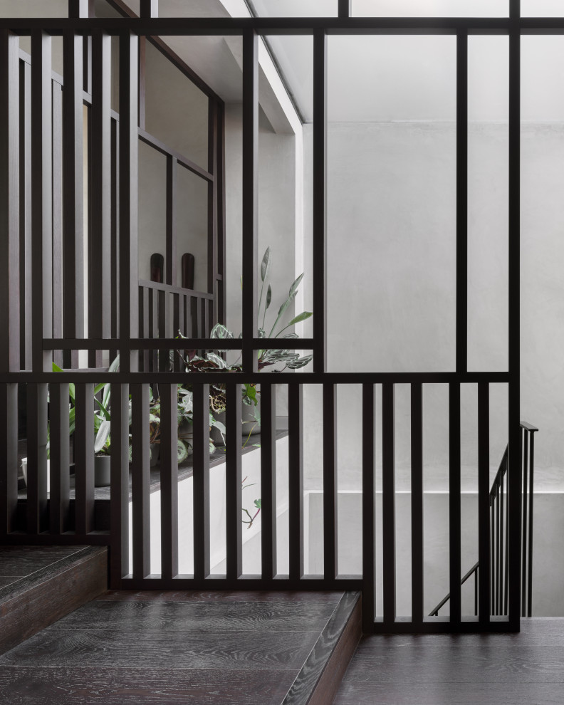 This is an example of a medium sized contemporary wood l-shaped metal railing staircase in London.