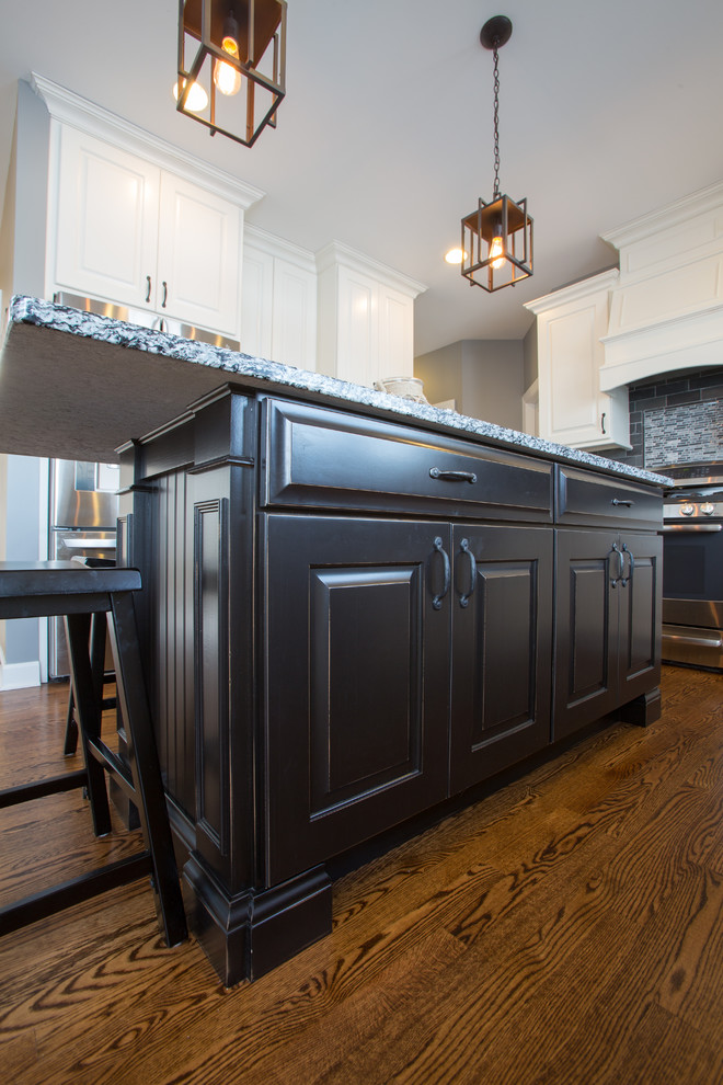 Large transitional u-shaped dark wood floor eat-in kitchen photo in Chicago with white cabinets, gray backsplash, stainless steel appliances and an island