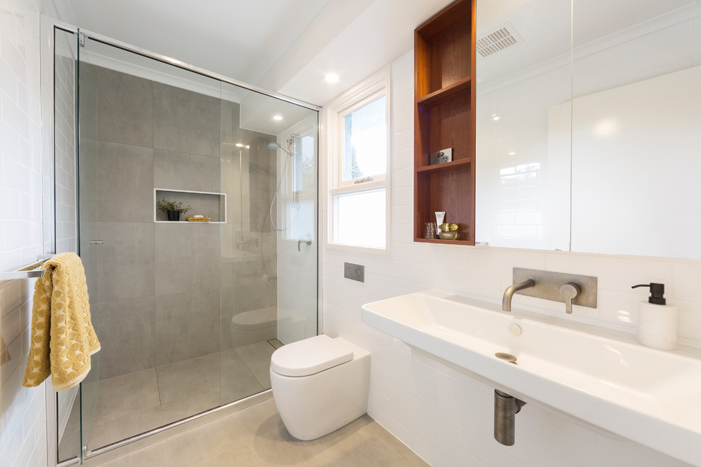 Inspiration for a contemporary bathroom in Canberra - Queanbeyan with ceramic tile, cement tiles, a wall-mount sink, grey floor and a hinged shower door.
