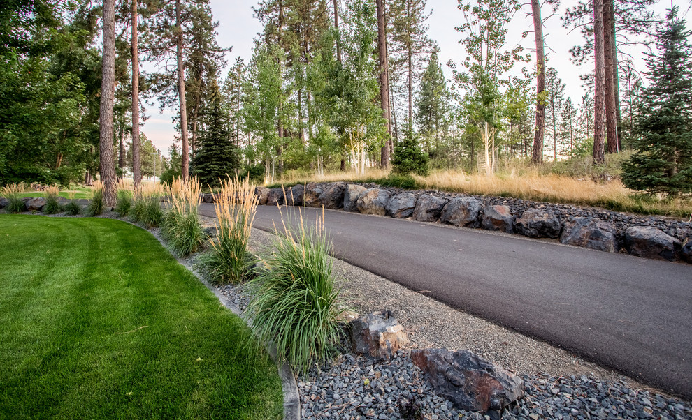 Inspiration for a huge rustic hillside concrete paver retaining wall landscape.