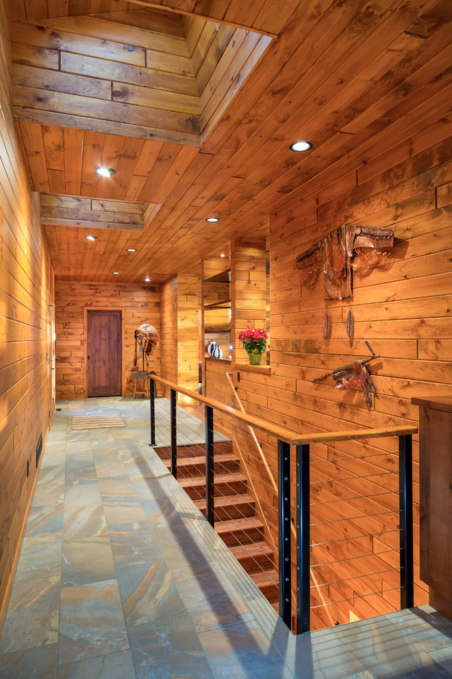 This is an example of a mid-sized country hallway in Minneapolis with brown walls, terra-cotta floors and multi-coloured floor.