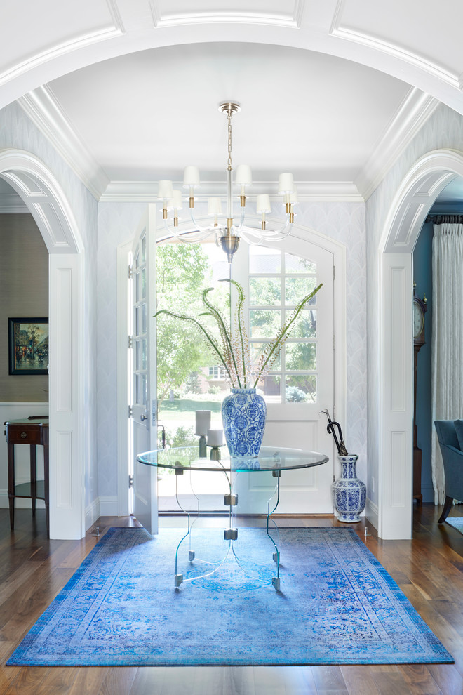 Inspiration for a mid-sized traditional foyer in Denver with medium hardwood floors, a double front door, a white front door, brown floor and grey walls.