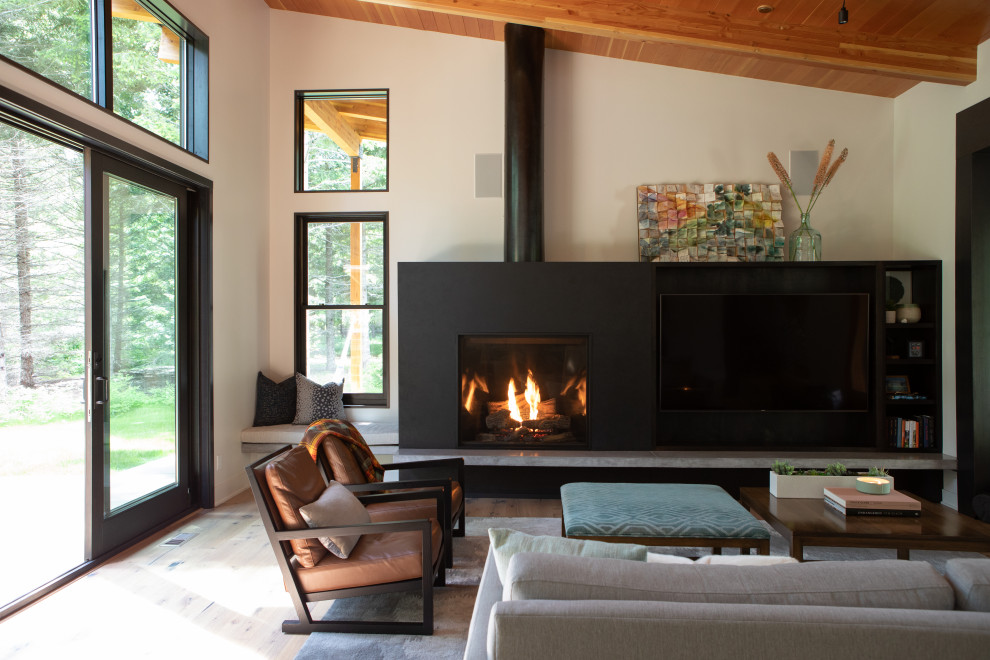 Mid-sized modern open concept living room in Seattle with white walls, medium hardwood floors, a standard fireplace, a concrete fireplace surround, a built-in media wall, brown floor and exposed beam.