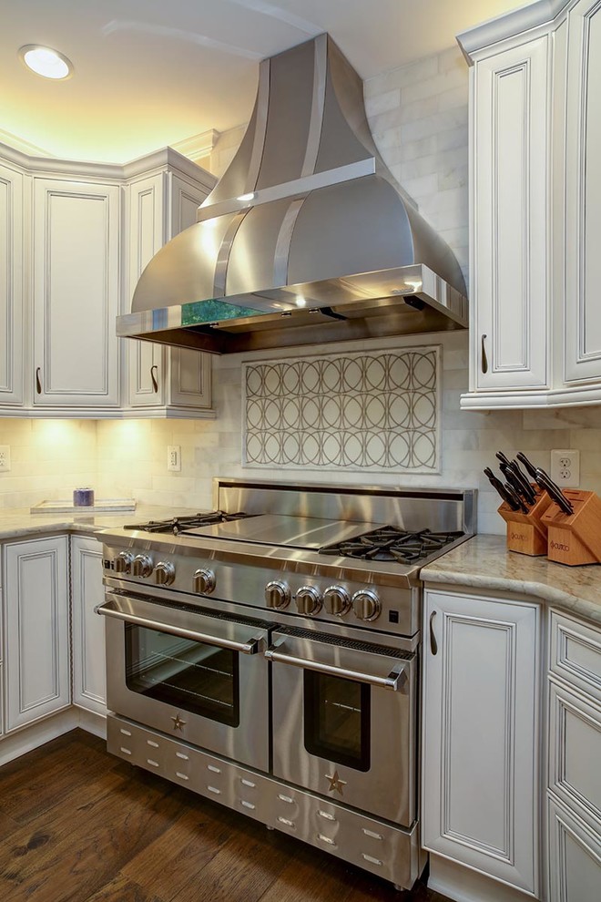 Inspiration for a transitional u-shaped dark wood floor eat-in kitchen remodel in Cedar Rapids with a farmhouse sink, flat-panel cabinets, white cabinets, marble countertops, stainless steel appliances and an island