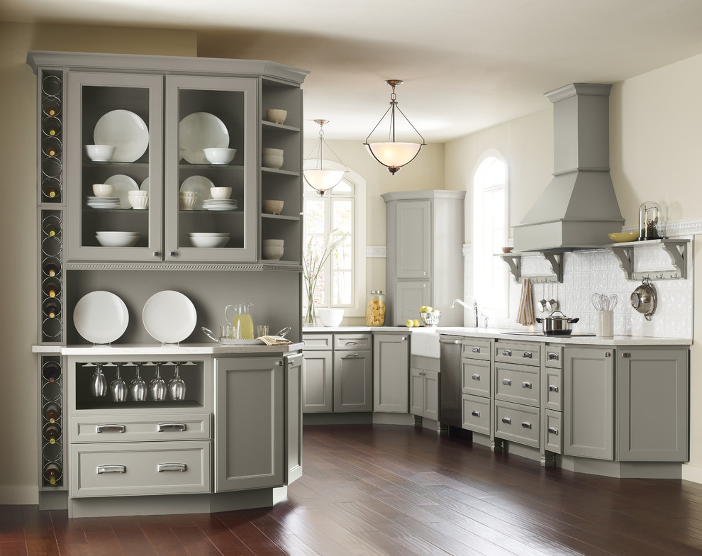 Design ideas for a large traditional u-shaped separate kitchen in New York with a farmhouse sink, recessed-panel cabinets, grey cabinets, window splashback, stainless steel appliances, dark hardwood floors, no island and brown floor.