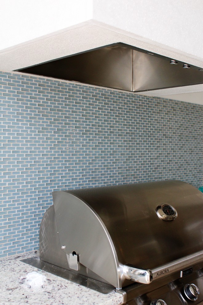 Inspiration for a large transitional galley home design remodel in Tampa with granite countertops, blue backsplash, glass sheet backsplash and stainless steel appliances