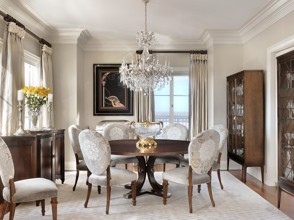 Inspiration for a mid-sized timeless medium tone wood floor enclosed dining room remodel in St Louis with beige walls and no fireplace