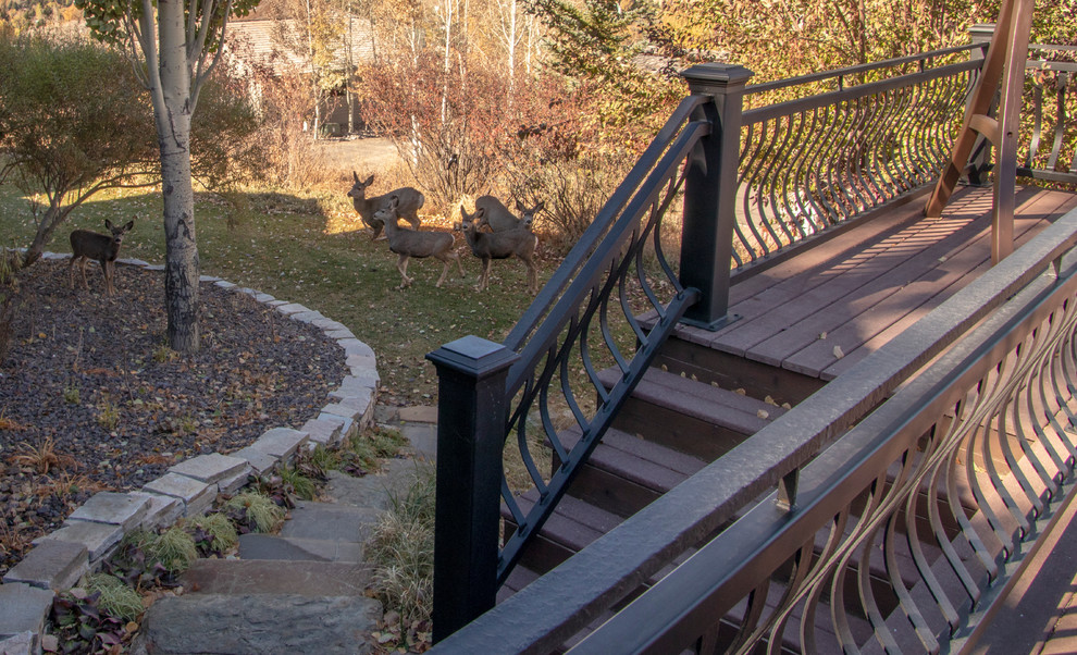 Large mountain style backyard deck photo with no cover