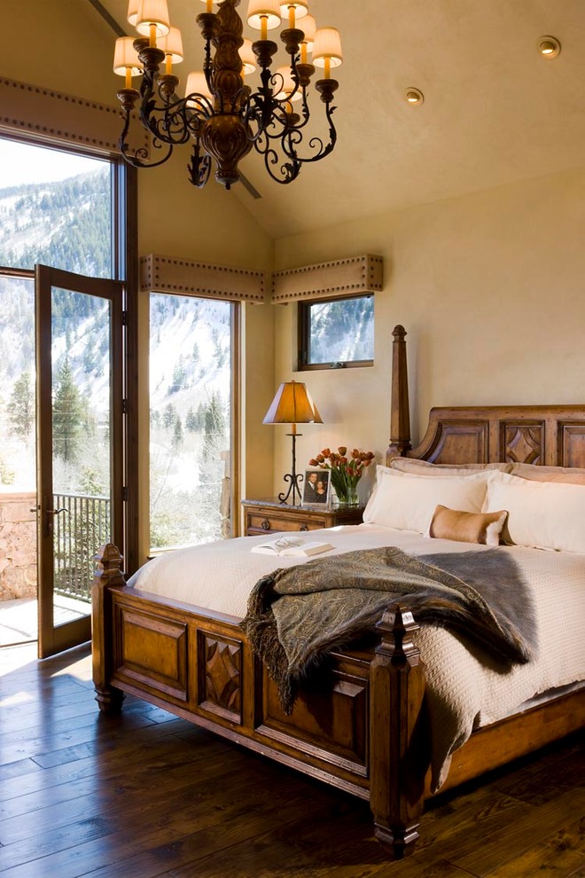 Photo of a traditional master bedroom in Denver with beige walls and dark hardwood floors.
