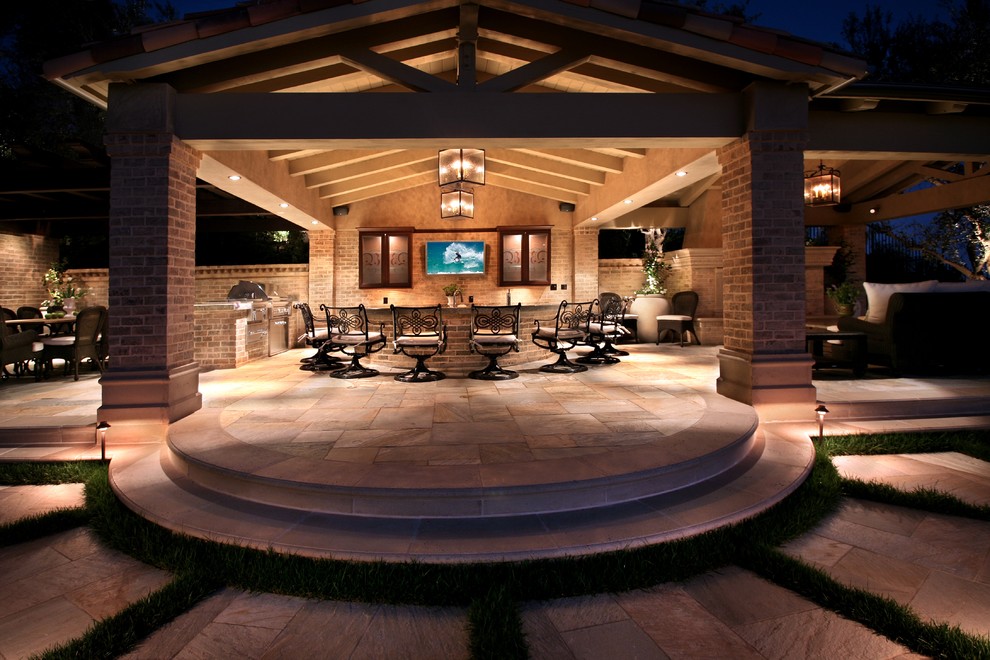 Design ideas for a mid-sized contemporary backyard patio in Orange County with a gazebo/cabana and natural stone pavers.