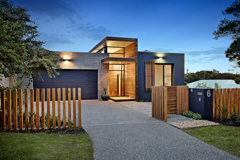 Contemporary blue exterior in Melbourne with mixed siding and a flat roof.