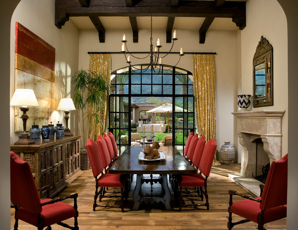 Design ideas for a large traditional separate dining room in Phoenix with beige walls, light hardwood floors, a standard fireplace and a stone fireplace surround.