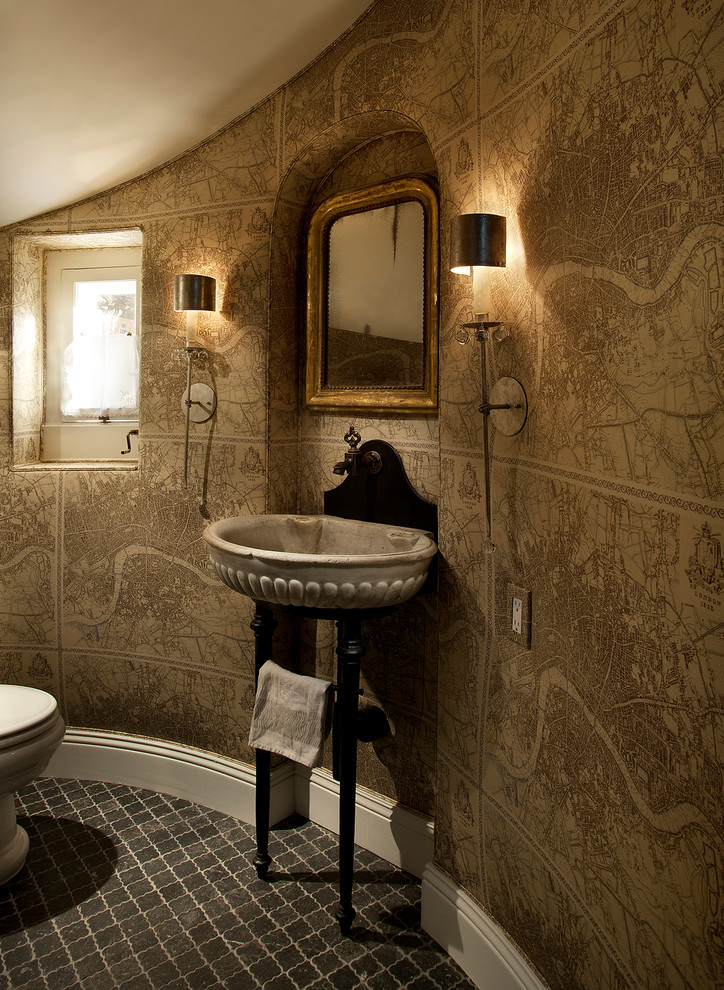 This is an example of a traditional powder room in Phoenix with a wall-mount sink and brown walls.