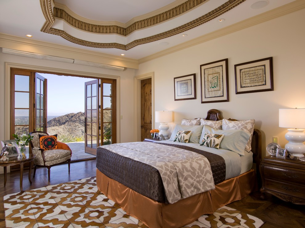 Mediterranean bedroom in Los Angeles with beige walls and dark hardwood floors.