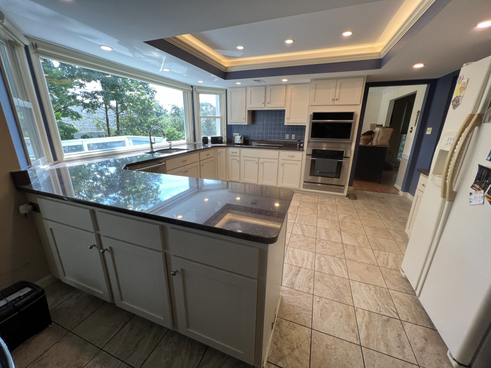 This is an example of a large modern u-shaped kitchen/diner in DC Metro with white cabinets.